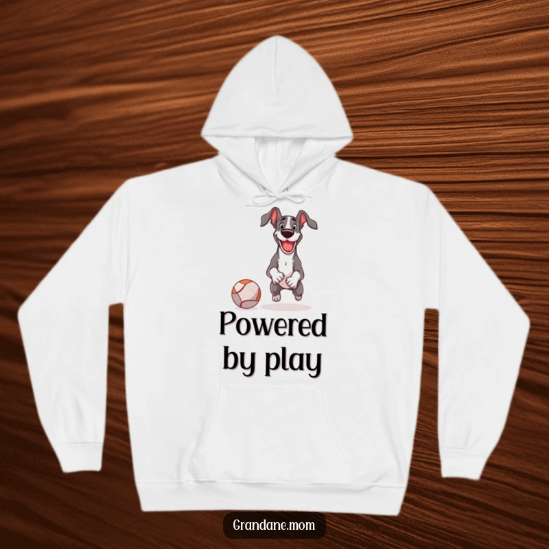 Funny Hoodie features a cheerful Great Dane enthusiastically playing fetch with an absurdly large ball, capturing pure delight.