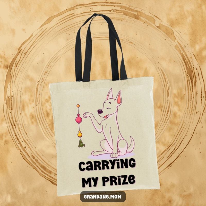 Funny Grand Dane tote bag showing a large dog reaching for a dangling toy, perfect for carrying items and bringing smiles.