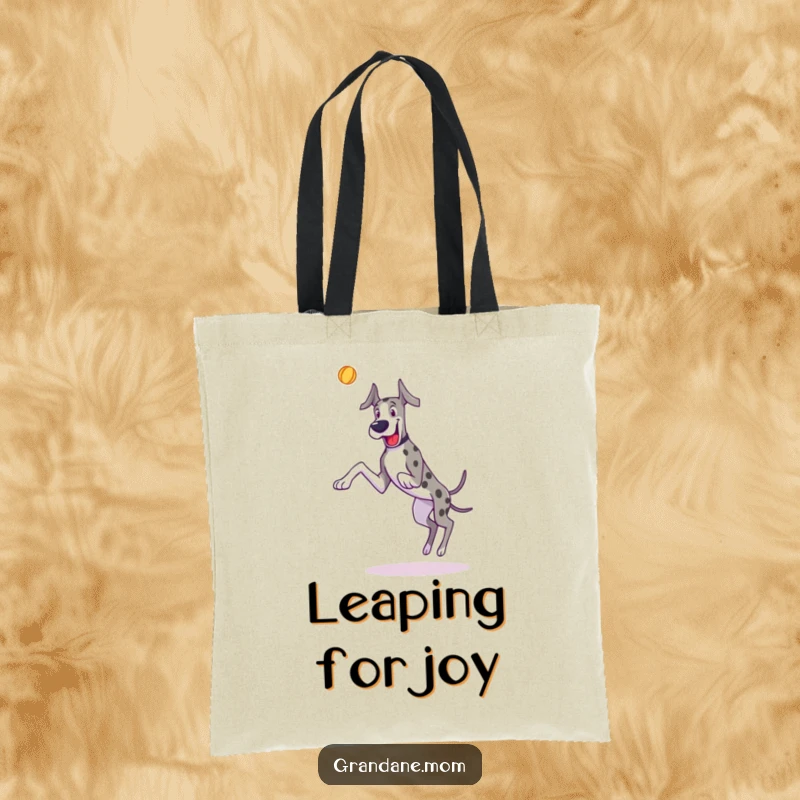 Funny Great Dane tote bag with a dog joyfully leaping to catch a toy, ideal for carrying items.